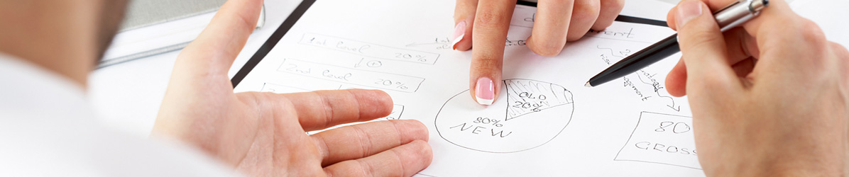 hands pointing to diagrams on paper